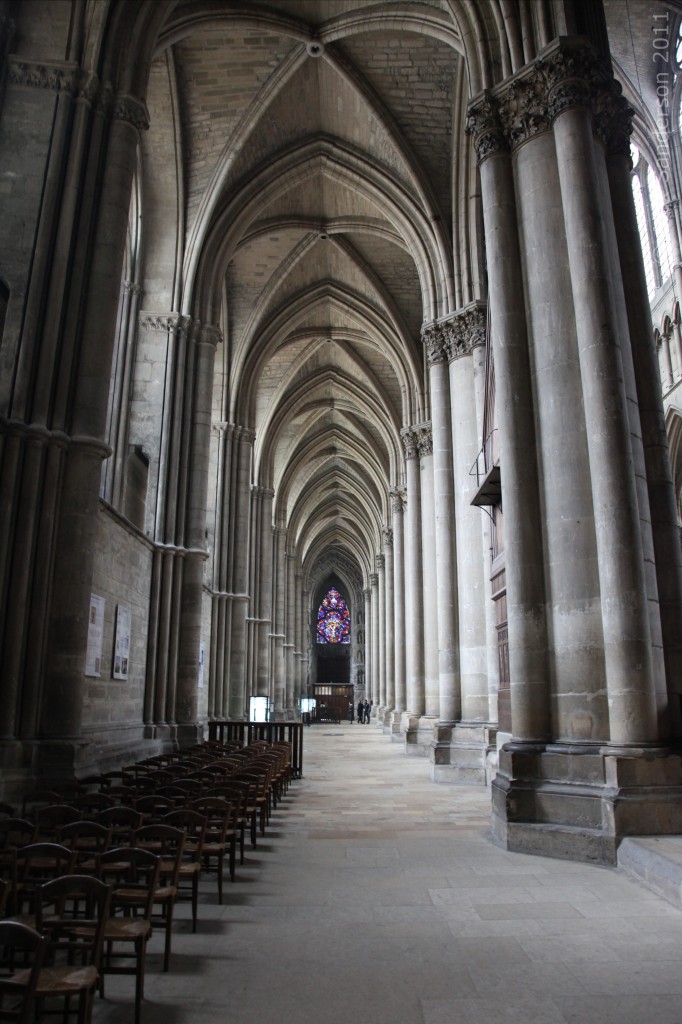 Inside Reims Cathedral looking down a side isle with beautiful vaulted roof